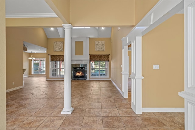 unfurnished living room featuring a chandelier, high vaulted ceiling, crown molding, and light tile patterned flooring