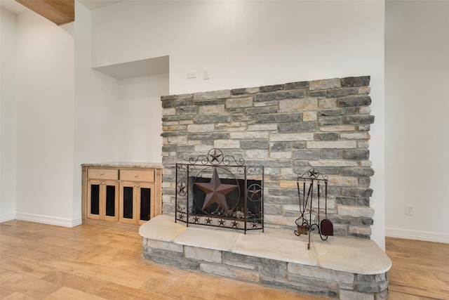 room details with a fireplace and hardwood / wood-style flooring