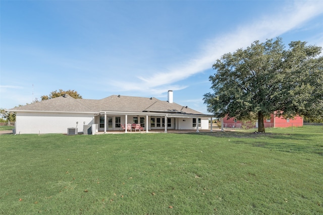 back of house featuring a lawn, central air condition unit, and a patio