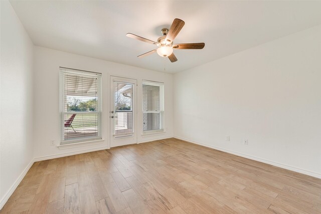 empty room featuring light wood-type flooring and ceiling fan