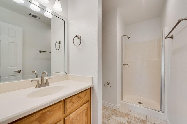 bathroom with a shower and vanity