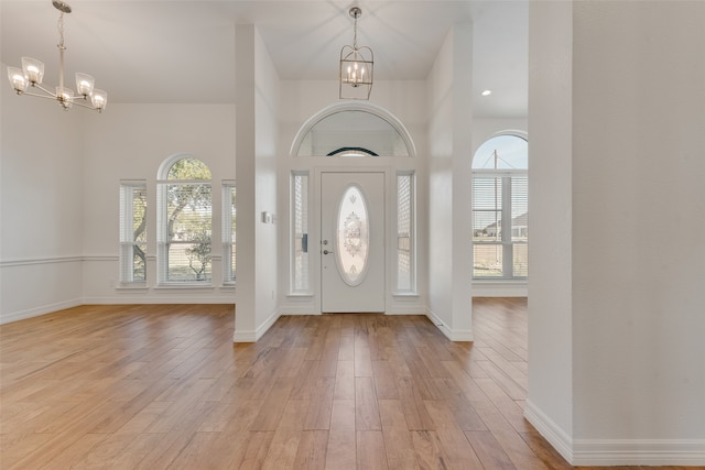 entrance foyer featuring light hardwood / wood-style flooring and a notable chandelier