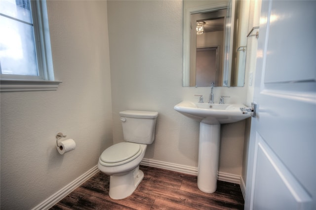 bathroom featuring hardwood / wood-style floors and toilet