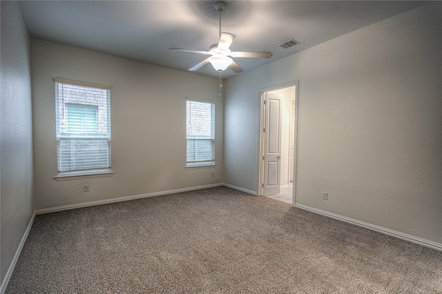 unfurnished room with ceiling fan and light carpet