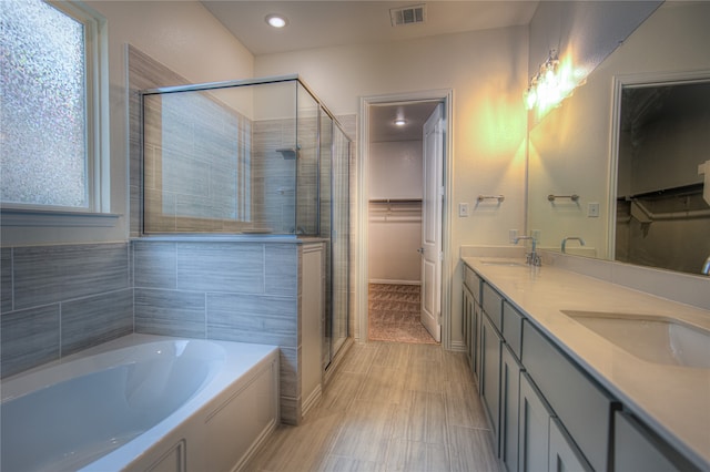 bathroom featuring vanity and separate shower and tub