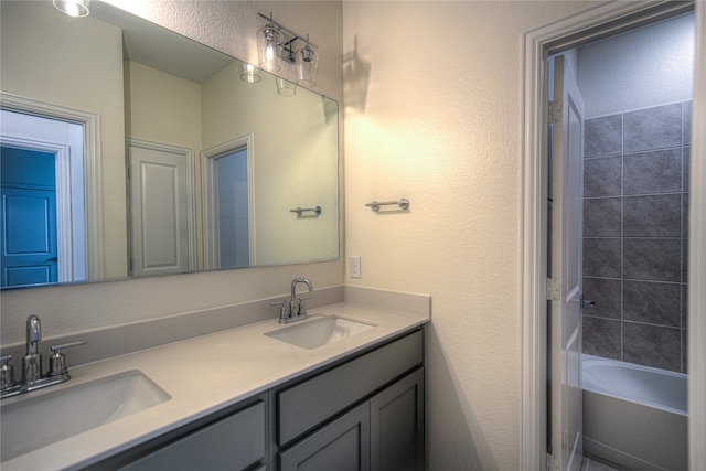 bathroom featuring vanity and tiled shower / bath combo