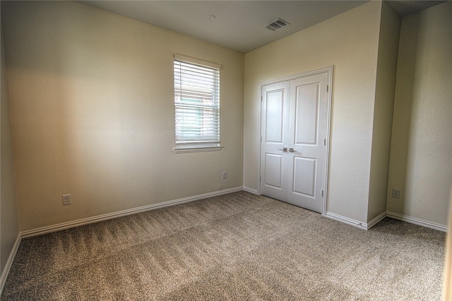 unfurnished bedroom with carpet floors and a closet