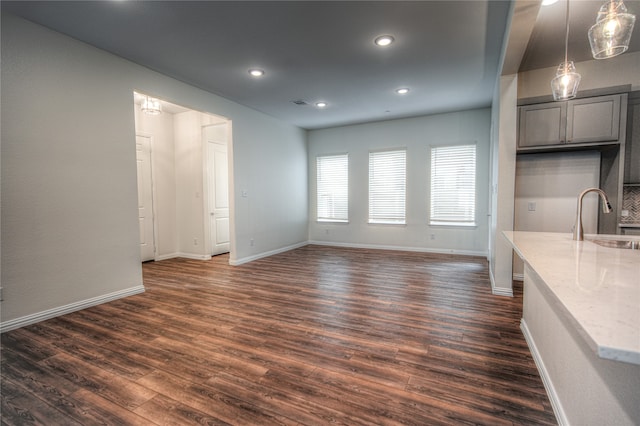 unfurnished dining area featuring dark hardwood / wood-style flooring and sink