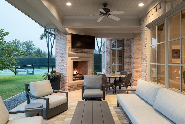 view of patio with an outdoor living space with a fireplace and ceiling fan