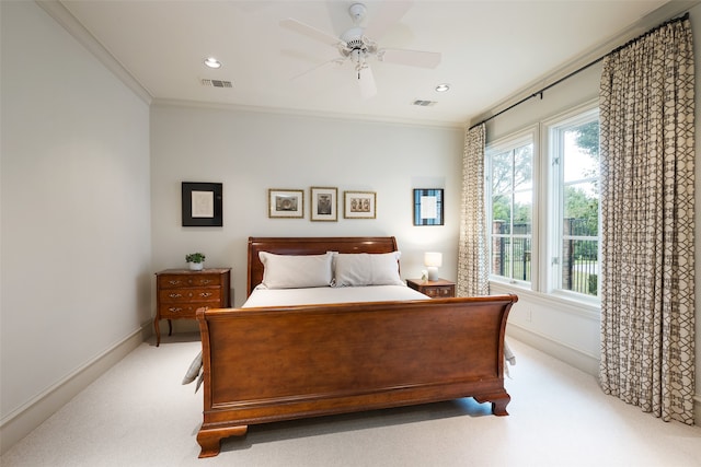 bedroom featuring ceiling fan, light colored carpet, and ornamental molding