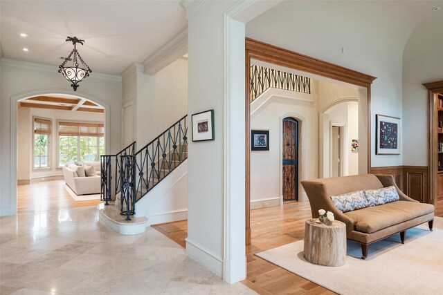 interior space with crown molding and light hardwood / wood-style floors