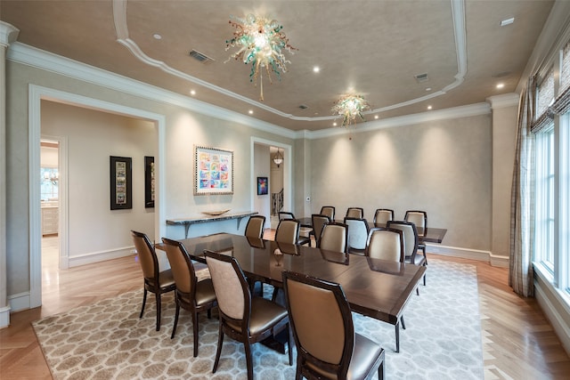 dining space with plenty of natural light, ornamental molding, and light parquet floors