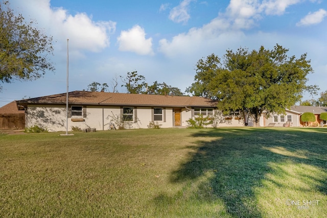 ranch-style home with a front lawn