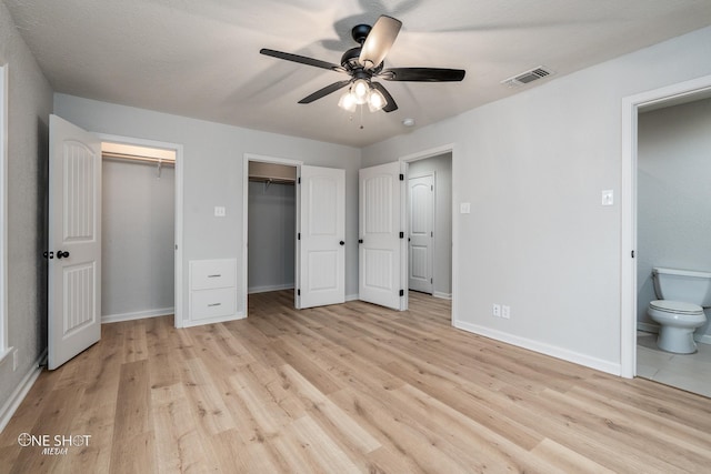 unfurnished bedroom with connected bathroom, ceiling fan, a textured ceiling, and light wood-type flooring