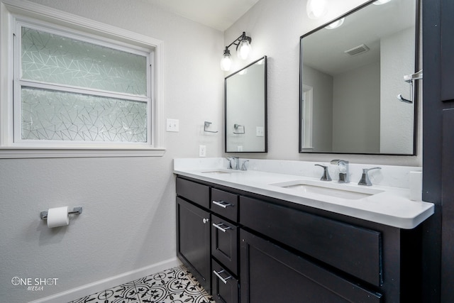 bathroom with tile patterned flooring and vanity