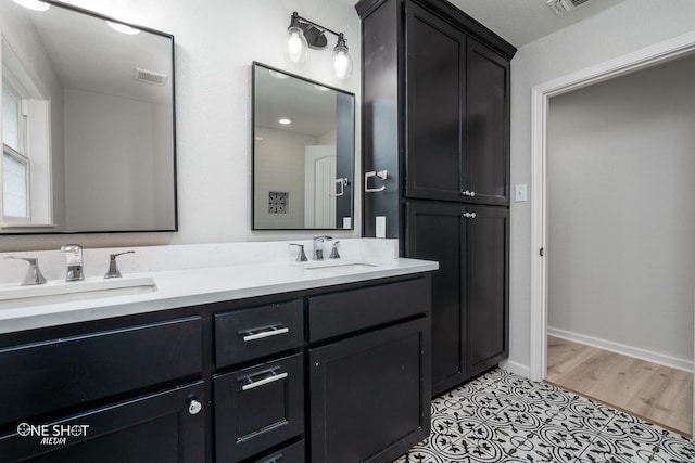 bathroom with hardwood / wood-style floors and vanity