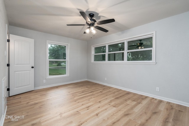 spare room with ceiling fan and light wood-type flooring