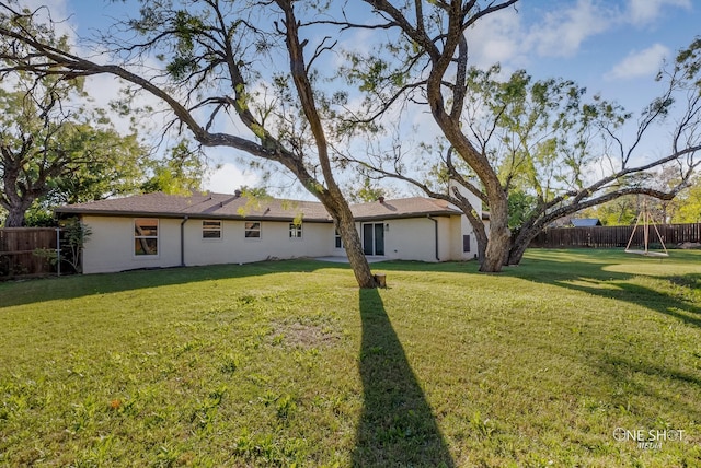 back of property with a lawn