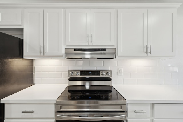 kitchen featuring ventilation hood, white cabinetry, electric range, and tasteful backsplash