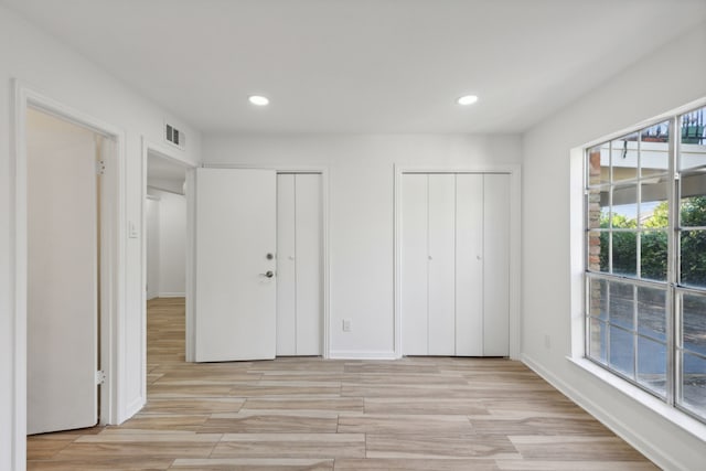 unfurnished bedroom with multiple closets