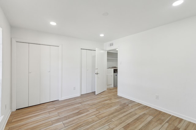 unfurnished bedroom featuring two closets