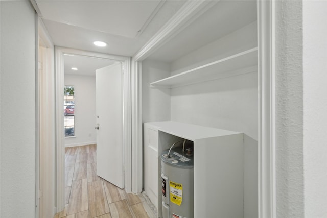 interior space featuring crown molding and water heater