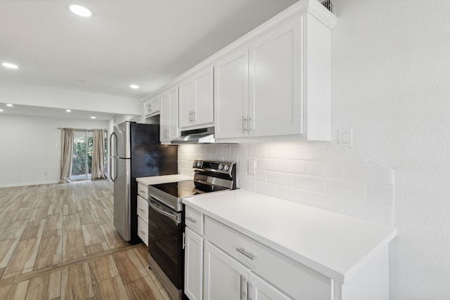 kitchen featuring white cabinets, decorative backsplash, stainless steel appliances, and light hardwood / wood-style flooring