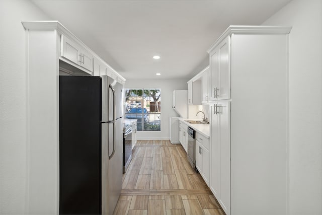 kitchen featuring white cabinets, sink, and stainless steel appliances