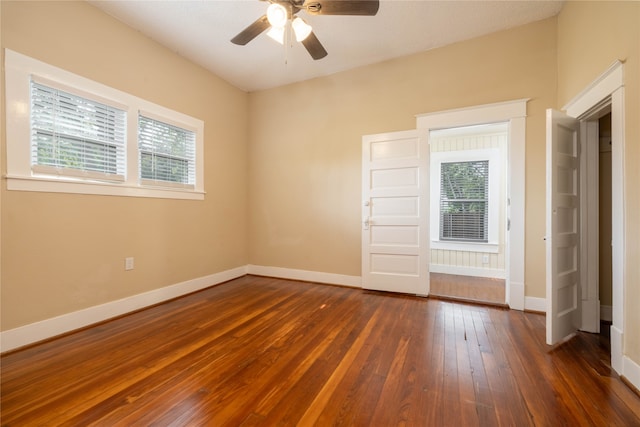 spare room featuring ceiling fan and dark hardwood / wood-style floors