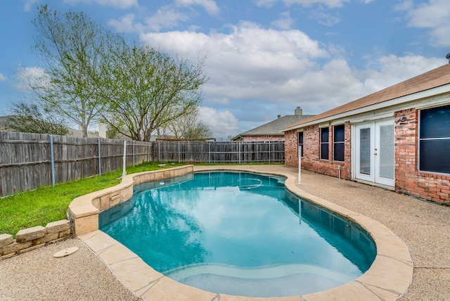 view of swimming pool featuring french doors