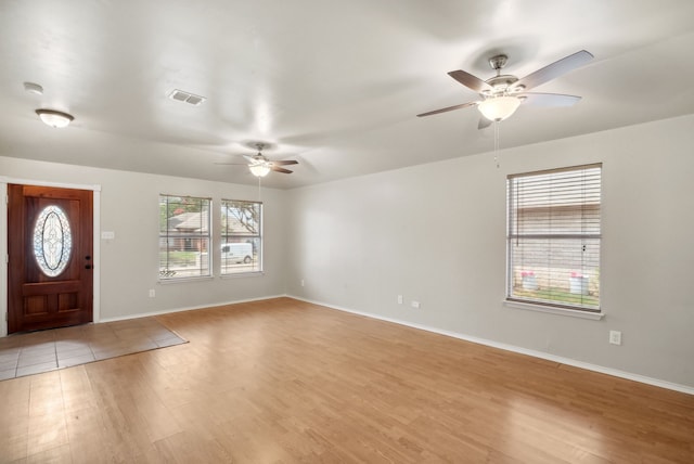 foyer entrance featuring ceiling fan and light wood-type flooring