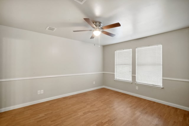 empty room featuring ceiling fan and light hardwood / wood-style flooring