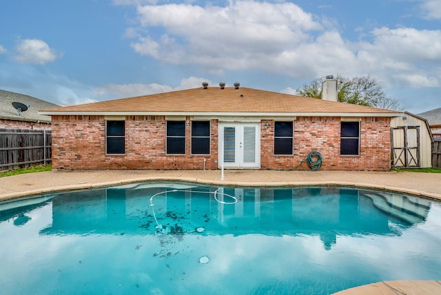 view of swimming pool featuring french doors