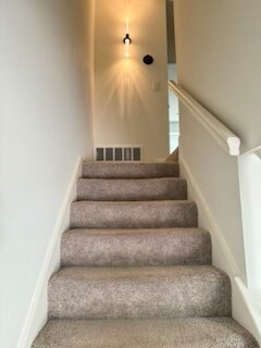 bedroom featuring dark colored carpet