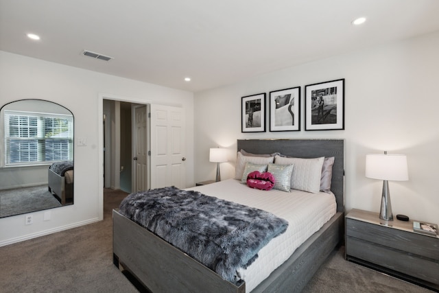 bedroom with baseboards, dark carpet, visible vents, and recessed lighting