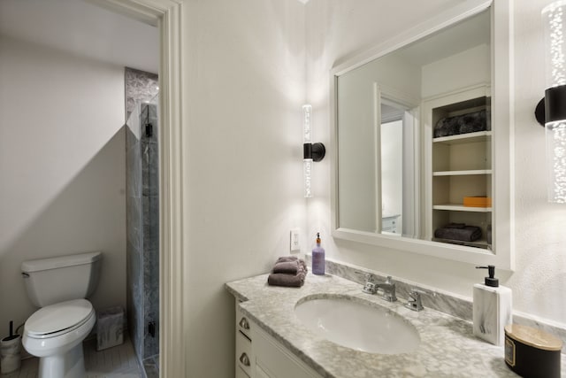 bathroom featuring vanity, toilet, and a shower