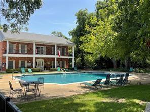 pool with a patio area and a yard