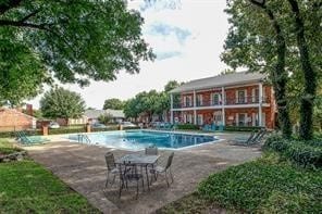 view of swimming pool with a patio area