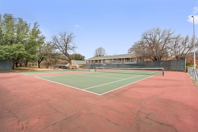 view of sport court featuring fence