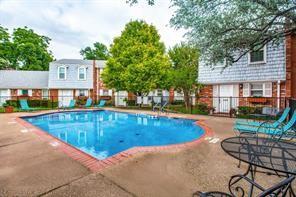 outdoor pool featuring a patio and fence