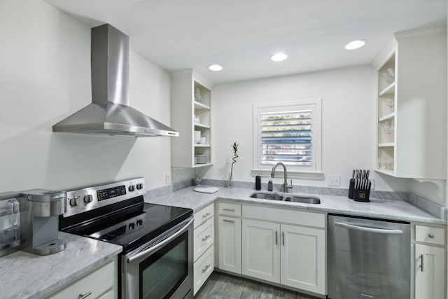 kitchen featuring wall chimney exhaust hood, stainless steel appliances, dark wood-type flooring, sink, and white cabinetry