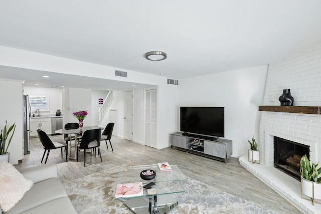 living room featuring a fireplace and light hardwood / wood-style floors