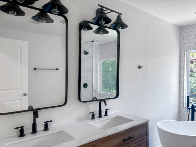 bathroom with a soaking tub, walk in shower, double vanity, and a sink