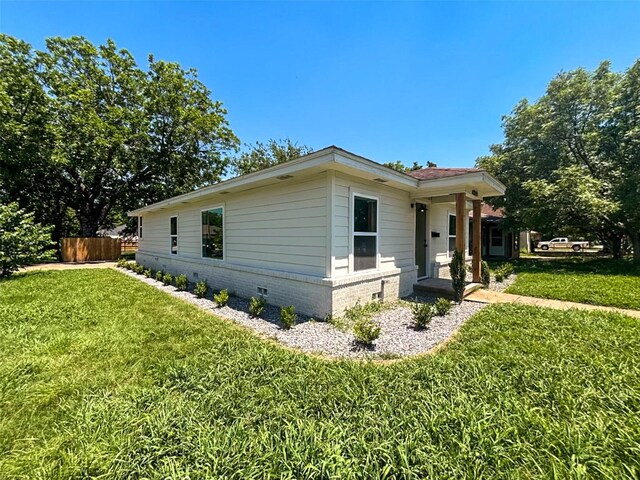 doorway to property featuring a lawn