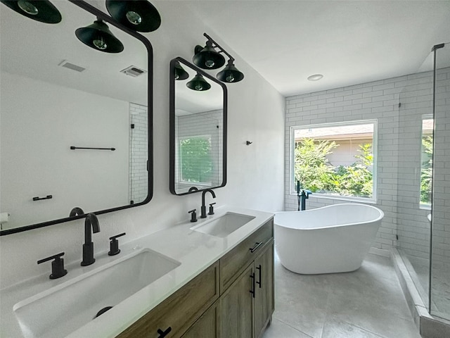 bathroom with a sink, visible vents, a soaking tub, and double vanity