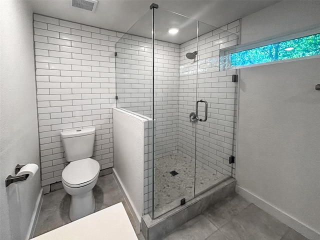 full bath featuring baseboards, visible vents, tile patterned flooring, a shower stall, and toilet