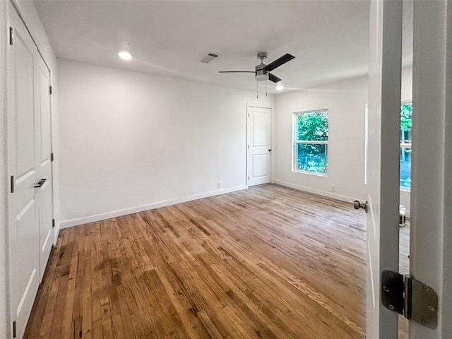 unfurnished bedroom with a ceiling fan, wood finished floors, visible vents, baseboards, and recessed lighting