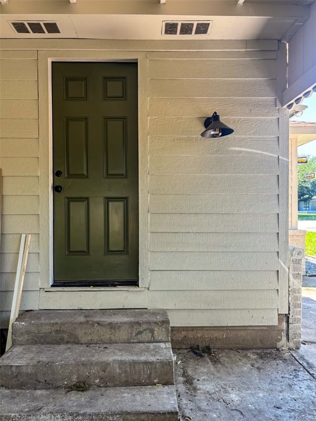 doorway to property featuring visible vents