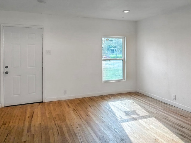 unfurnished room featuring baseboards and wood finished floors