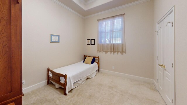 bedroom with light colored carpet and crown molding